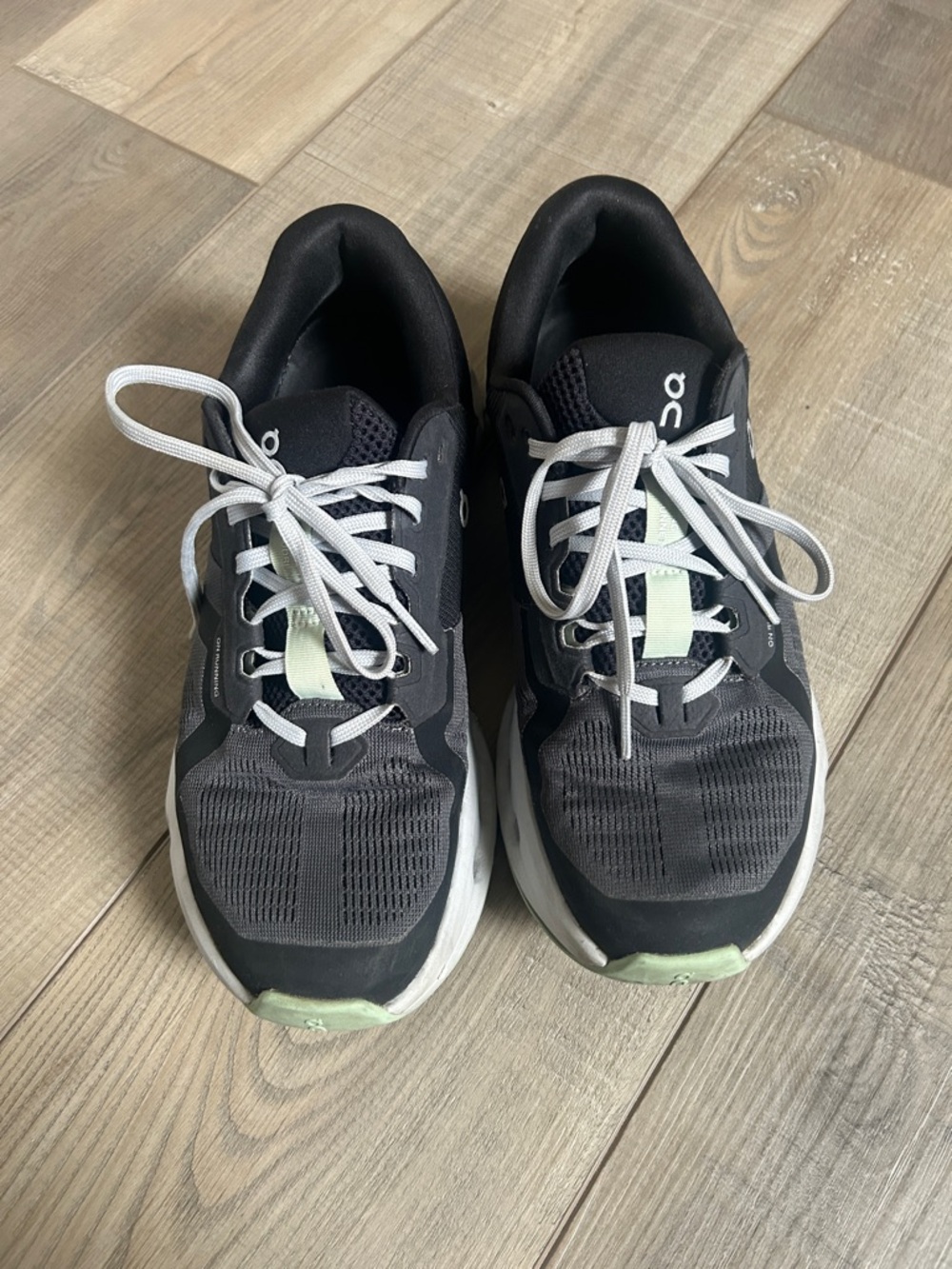 On Running Black Sneakers with Light Green Accents
